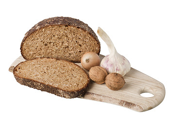 Image showing brown bread on shelf with onion, garlic and walnut