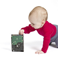 Image showing young child in white background with hard drive