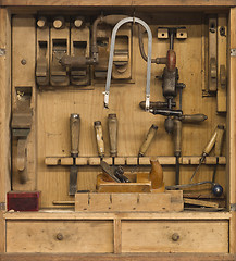 Image showing carpenters tools in a wooden cabinet