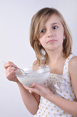 Image showing thoughful child with a bowl of milk porridge