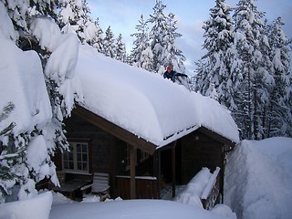 Image showing Clearing snow off the roof