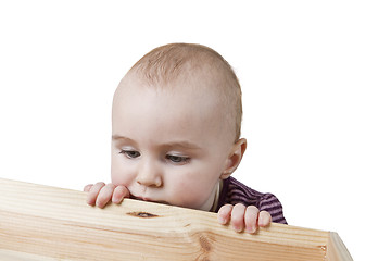 Image showing baby looking into wooden box