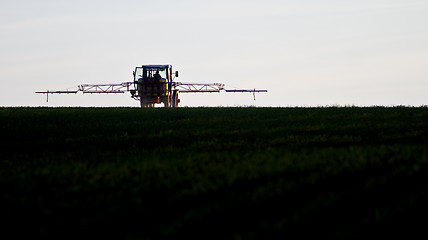 Image showing tractor spraying agricultural pesticide
