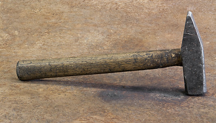 Image showing hammer on rusty steel plate