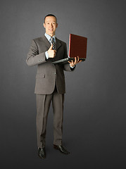 Image showing Full length portrait of businessman with laptop