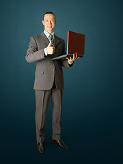 Image showing Full length portrait of businessman with laptop