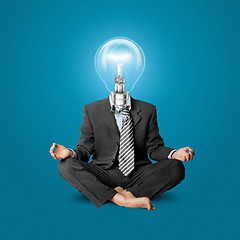 Image showing lamp-head businessman in lotus pose