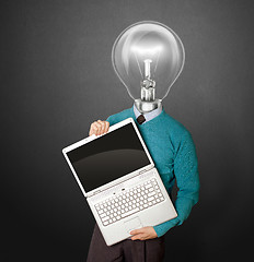 Image showing Male with lamp-head in blue with laptop