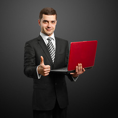 Image showing male in suit with laptop in his hands