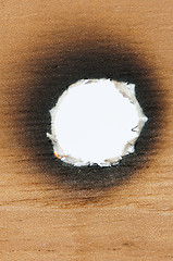 Image showing Burned wooden paper and hole