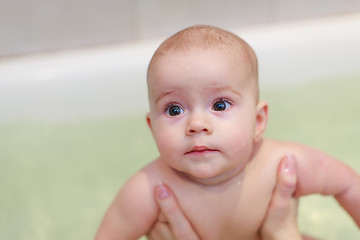 Image showing Small baby bathing