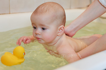 Image showing Small baby bathing