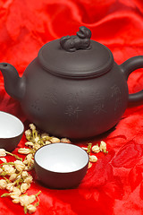 Image showing jasmine tea over red silk