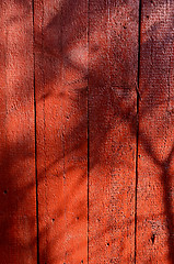 Image showing Shadows on red-painted wooden wall. 