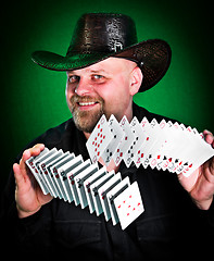 Image showing man skilfully shuffles playing cards