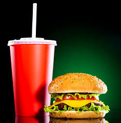 Image showing Tasty and appetizing hamburger on a darkly green