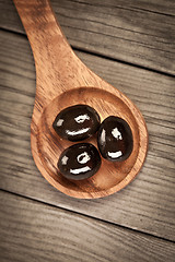 Image showing Olives on a wooden table