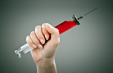 Image showing Old medical syringe on a grey background