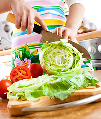 Image showing Woman's hands cutting vegetables