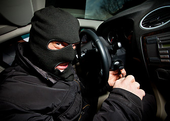 Image showing robber and the thief in a mask hijacks the car