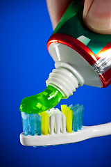 Image showing toothpaste being squeezed onto a toothbrush