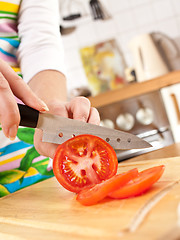 Image showing Woman's hands cutting tomato