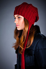 Image showing Portrait of the young girl in a winter cap on the dark