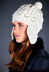 Image showing Portrait of the young girl in a winter cap on the dark