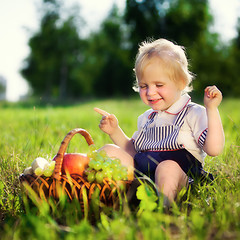 Image showing little boy with a basket of fruit