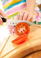 Image showing Woman's hands cutting tomato