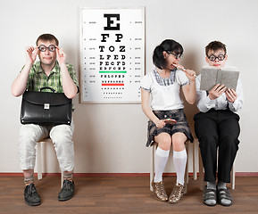 Image showing three person wearing spectacles in an office at the doctor