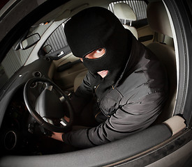 Image showing robber and the thief in a mask hijacks the car