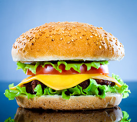 Image showing Tasty and appetizing hamburger on a blue