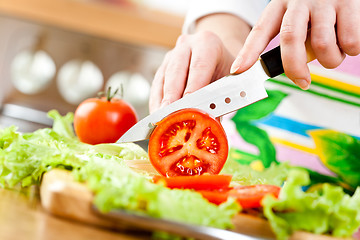 Image showing Woman's hands cutting vegetables