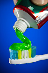Image showing toothpaste being squeezed onto a toothbrush