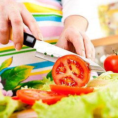 Image showing Woman's hands cutting vegetables