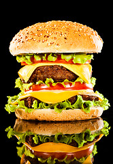 Image showing Tasty and appetizing hamburger on a dark