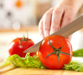 Image showing Woman's hands cutting vegetables