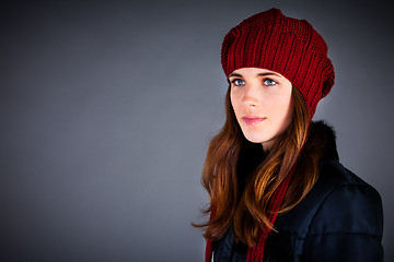 Image showing Portrait of the young girl in a winter cap on the dark