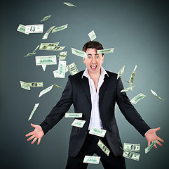 Image showing man in a suit throws money