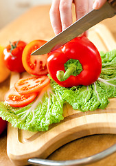 Image showing Woman's hands cutting vegetables