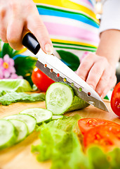 Image showing Woman's hands cutting vegetables