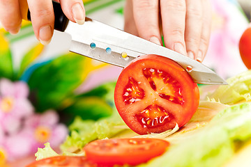 Image showing Woman's hands cutting vegetables