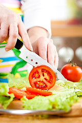 Image showing Woman's hands cutting vegetables