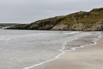 Image showing sandy coastline with hill in background