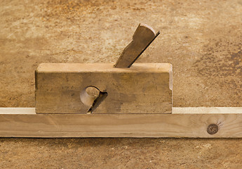 Image showing planer on wood in brown background