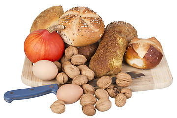 Image showing gem, nuts, eggs and a pumpkin on a wooden board