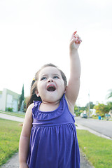 Image showing happy little girl three years old signing the sky