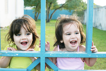 Image showing Portrait of happy two sisters outdoors having fun