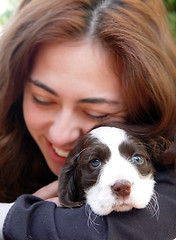 Image showing A happy girl holding her dog